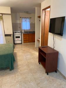 a living room with a flat screen tv on a wall at Tony Center IV in Las Toninas