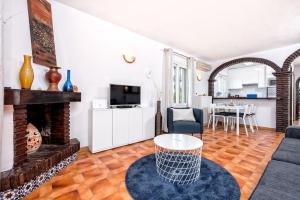 a living room with a couch and a fireplace at F04 Bahia Playa - Apartment in Mijas Costa