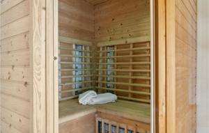 a wooden sauna with a white towel in it at Three-Bedroom Holiday Home In Askeby in Askeby