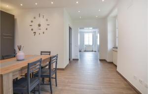 a dining room with a table and a clock on the wall at 2 Bedroom Gorgeous Home In Bonassola in Bonassola +17 photos