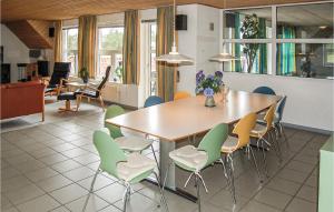 a dining room with a table and chairs at Holiday Home Søren Lassens Vænge Blåvand Denm in Blåvand