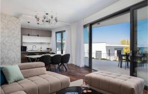 a living room with a couch and a table with chairs at Pet Friendly Home In Zidarici With Wifi in Vantačići