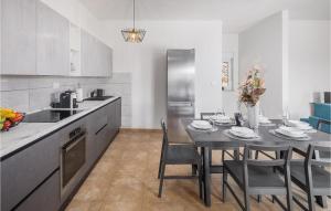 a kitchen with a table with chairs and a dining room at Beautiful Home In Koromacno With Wifi in Koromačno