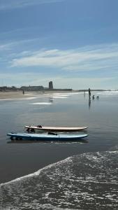 two surfboards sitting on the sand on a beach at Casa a 65 metros de la Playa in El Palmar