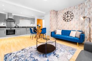 a living room with a blue couch and a table at LUXURY SEA BLUE-Birmingham central apartment in Birmingham