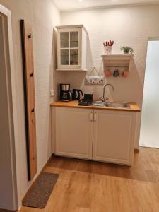 a kitchen with a sink and a counter top at Ferienhaus Fachwerk 97 in Stolberg +8 photos
