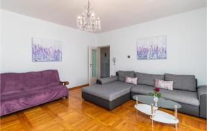 a living room with a couch and a table at 2 Bedroom Gorgeous Apartment In Pobri in Volosko
