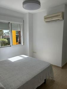 a white bedroom with a bed and a window at Magnífico apartamento en Vera in Vera +31 photos