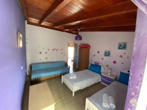 A bed or beds in a room at Nikos Studios Meltemi Family Suite Penthouse