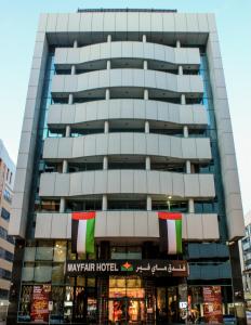 a large building with a happy tenant hotel at Grand Mayfair Hotel in Dubai