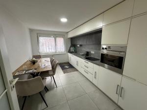 a kitchen with a table and a dining room at Stilvolles Apartment im modernen Ambiente in Tuttlingen in Tuttlingen