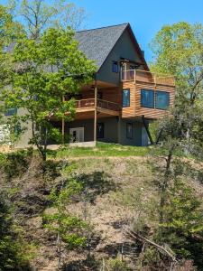 a large house on a hill with trees at Lakefront 3BR Cabin Retreat in Samantha