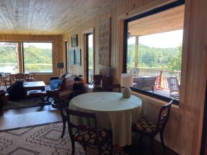 a living room with a table and a large window at Lakefront 3BR Cabin Retreat in Samantha