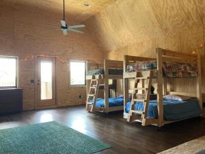 a room with four bunk beds and a ceiling at Lakefront 3BR Cabin Retreat in Samantha