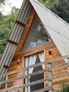 a tree house with a window on the side of it at Cabanas Bela Vista in Rolante