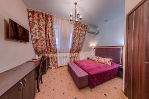a hotel room with a bed and a window at Elbrus Hotel in Cheboksary