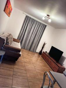 a living room with a couch and a television at Casa Eni in Cluj-Napoca +15 photos