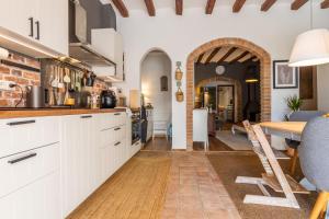 a kitchen with white cabinets and a wooden table at Espectacular pis al mig de Reus in Reus +27 photos
