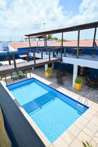 a pool on the roof of a hotel at Pousada Costa Prestige in Touros