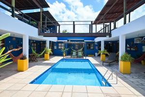 a pool in the middle of a building at Pousada Costa Prestige in Touros