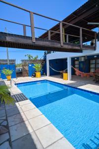 a swimming pool in front of a house at Pousada Costa Prestige in Touros