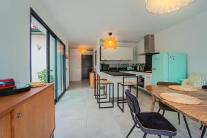 une cuisine et une salle à manger avec une table et des chaises dans l'établissement La contemporaine 2 chambres à Ste Marie, à Sainte-Marie-la-Mer