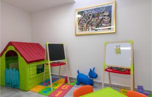 a play room with a toy dog house and a chalkboard at Villa Makarac in Milna