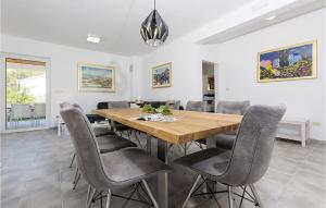 a dining room with a wooden table and chairs at Villa Makarac in Milna