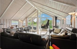 a living room with leather couches and a table at Holiday Home Vandstedet Ix in Nordborg