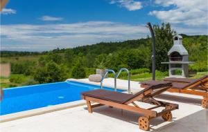 een zwembad met 2 ligstoelen naast een zwembad bij Villa Pilati in Poreč +47 foto's