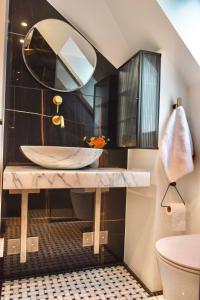 a bathroom with a sink and a mirror at Central Penthouse with Private Rooftop Terrace in Copenhagen +37 photos
