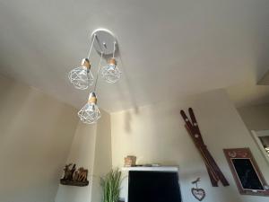 a room with three lights hanging from the ceiling at La casa del Sole in Castel di Sangro