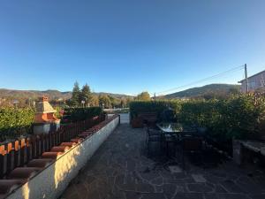 a patio with a table and chairs and a fence at La casa del Sole in Castel di Sangro