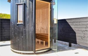 a wooden outhouse with a wooden bench inside of it at Cozy Home In Hvide Sande With Wifi in Bjerregård +31 photos