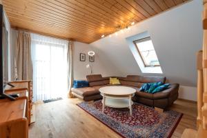 a living room with a couch and a table at Ackerweg, App 01 in Ueckeritz