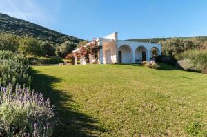 ein Haus auf einem Feld mit einem Rasenplatz in der Unterkunft Villa Maremonti in Santa Lucia