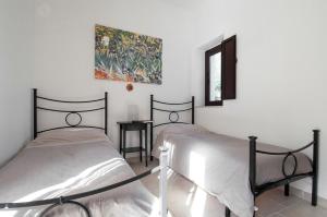 ein Schlafzimmer mit zwei Betten und einem Gemälde an der Wand in der Unterkunft Villa Maremonti in Santa Lucia + 38 Fotos