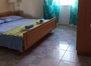 a bedroom with a bed with two towels on it at Apartments Sova in Postira