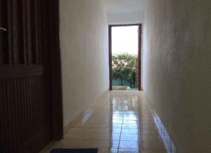 an empty hallway with a door and a tile floor at Apartments Sova in Postira