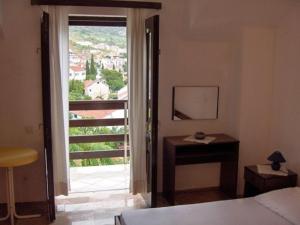 a bedroom with a large window with a view at Apartments Matej in Bol