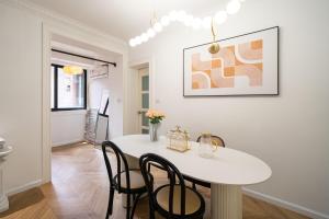 a white dining room with a white table and chairs at Shanghai Hills & Serendipity Springtime Family BNB with Two Rooms close to West Nanjing Rd in Shanghai