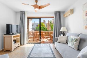 a living room with a couch and a ceiling fan at 2x bedrooms Heated Pool Holiday in Amarilla Golf FC2613-2xE in San Miguel de Abona