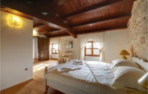 a bedroom with a large bed with wooden ceilings at Villa Moncalvo in Rovinj