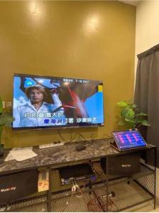 a flat screen tv sitting on top of a table at RALI PD HOME D 16Pax karaoke and swimming pool in Port Dickson