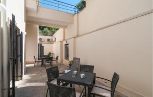 an outdoor patio with tables and chairs and a balcony at Gorgeous Apartment In Selca With Wifi in Selca