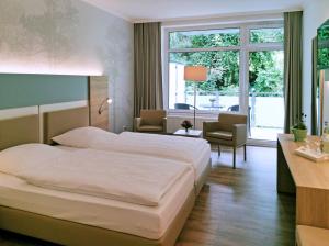 Postel nebo postele na pokoji v ubytování Waldhotel Felsenkeller