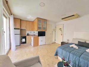 a large bedroom with a bed and a kitchen at Atico A Cartagena centro historico Parking in Cartagena +28 photos