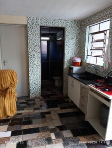 a kitchen with a sink and a counter top at Casa confortavel in Ponta Grossa
