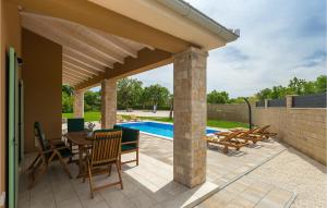 un patio con tavolo e sedie e una piscina di Villa Matea a Pola (Pula) Altre 48 foto