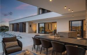 a house with a dining table and chairs at Villa La Reina Brtonigla in Brtonigla